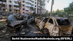 Burned-out cars lie strewn across a street on June 23 following a Russian strike on Kyiv. 