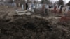 Воронка от снаряда на кладбище поселка Сартана