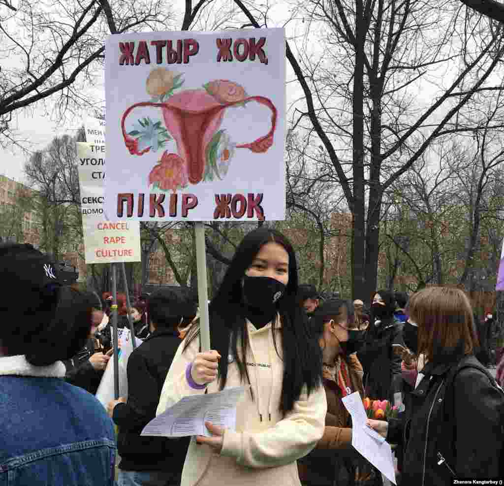 На некоторых плакатах были не только лозунги, но и художественные арты. Участник марша держит плакат «Нет матки — нет мнения». 